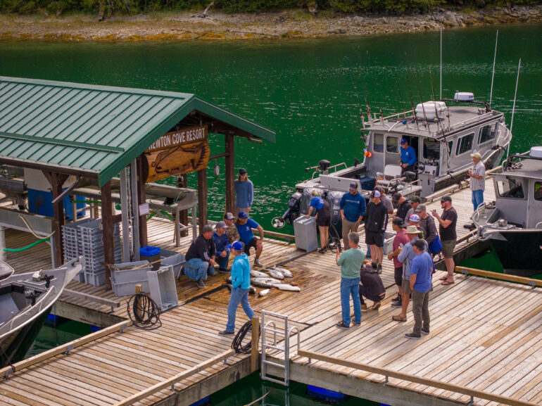 corporate group together on dock looking at fish